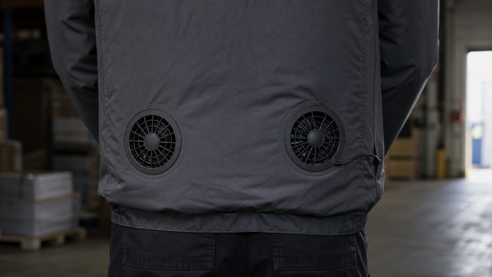 Close-up of the two hip fans and battery cable on a fan jacket (illustration)